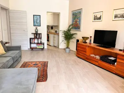 a living room with a flat screen tv on a entertainment center at Sunshine Eco Residence in Rome