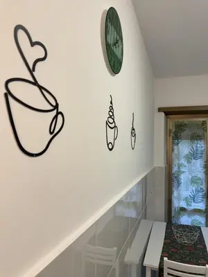 a room with a staircase with a clock on the wall at Home Fermi 80 in Rome
