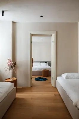 a bedroom with two beds and a door leading to a bedroom at C10 Boutique Hotel in Rome