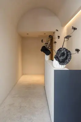 a room with two vases and flowers on a wall at C10 Boutique Hotel in Rome