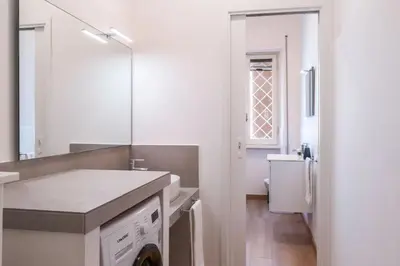 a bathroom with a sink and a washing machine at Pinturicchio's Key in Rome