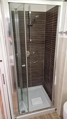 a shower with a glass door in a bathroom at Susy's Guest House Room San Pietro in Rome