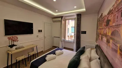 a living room with a couch and a tv at Susy's Guest House Room San Pietro in Rome