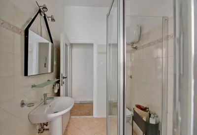 a bathroom with a sink and a toilet and a shower at Residenza Santa Barbara in Rome
