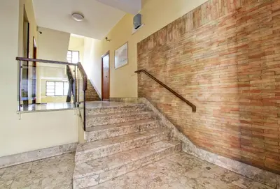 a staircase in a building with a brick wall at Residenza Santa Barbara in Rome