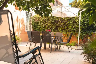 a table and chairs with an umbrella on a patio at Il giardino di San Pietro - 10 minuti dai Musei Vaticani in Rome
