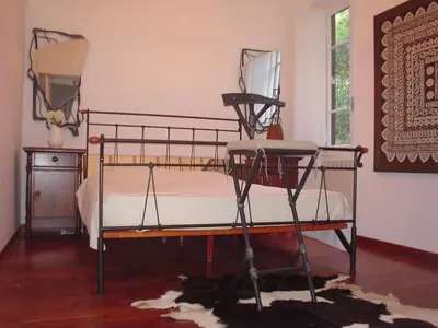 a bedroom with a bed with a metal frame at House Maximo at Colosseum in Rome