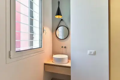 a bathroom with a sink and a window at Oasi Piceni Apartment San Lorenzo in Rome