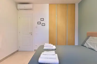 a room with a bed with three towels on it at Oasi Piceni Apartment San Lorenzo in Rome