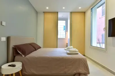 a bedroom with a bed with towels on it at Oasi Piceni Apartment San Lorenzo in Rome