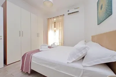 a white bed in a room with a window at 4BNB - Cavalleggeri Apartment in Rome
