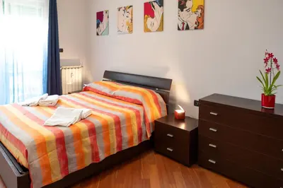 a bedroom with a bed with a dresser and a drawer at Pigneto Holiday in Rome