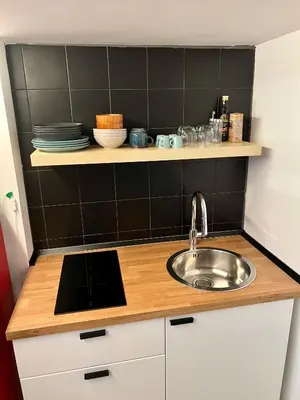 a kitchen with a sink and a shelf with dishes at Charming Navona - The Loft in Rome