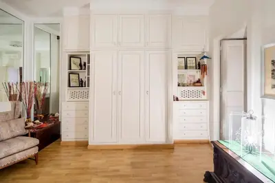 a living room with white cabinets and a couch at Appartamento elegante Castel Sant'Angelo in Rome
