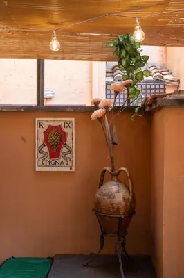 a vase sitting on a shelf with a plant in it at Arco del Calidarium - Pantheon in Rome