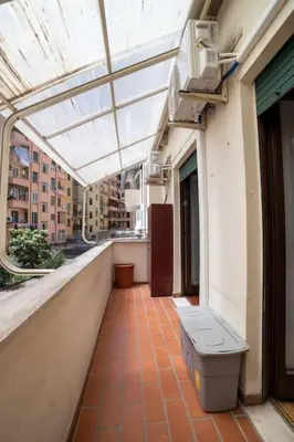 a balcony of a building with a glass roof at Richard & Lulù in Rome in Rome