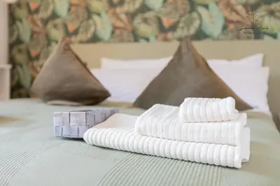 a pile of towels sitting on a bed at Gemma House - 100mt to Metro Station, 2 En-Suite bathrooms in Rome