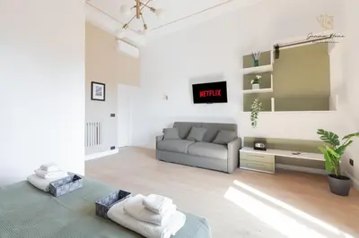 a living room with a couch and a tv at Gemma House - 100mt to Metro Station, 2 En-Suite bathrooms in Rome