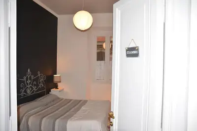 a bedroom with a bed with a black headboard at Cosy Apartment - 5 Minutes Walk from Colosseum in Rome