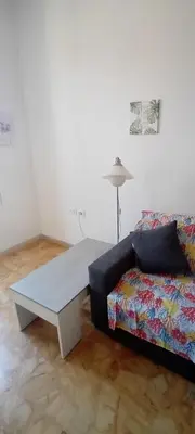 a living room with a couch and a coffee table at Cosy Apartment - 5 Minutes Walk from Colosseum in Rome