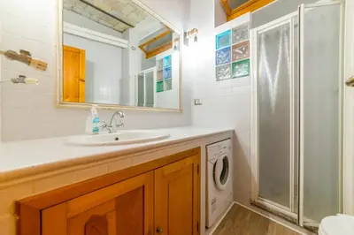 a bathroom with a sink and a washing machine at Appartamento via di Montegiordano in Rome
