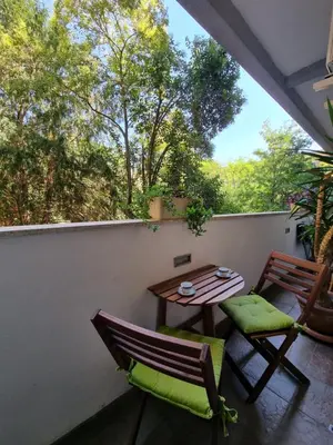 a patio with a table and chairs on a balcony at Parco della Musica House in Rome