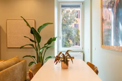 a dining room table with a plant on it at Casa Barbieri boutique apartment Flaminio in Rome