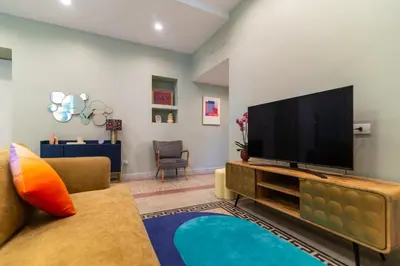 a living room with a large flat screen tv at Casa Barbieri boutique apartment Flaminio in Rome