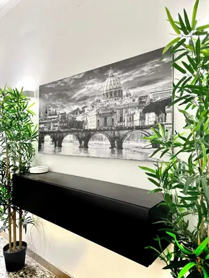 a dining room with a table and a potted plant at Orti Apartment in Rome