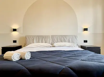 a bedroom with a large bed with two towels on it at Casa Fernanda in Rome