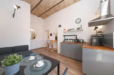 a kitchen and a living room with a table at Elena's Apartment - Piramide Metro Station in Rome