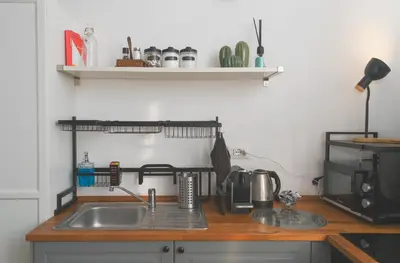 a kitchen counter with a sink and a microwave at Elena's Apartment - Piramide Metro Station in Rome