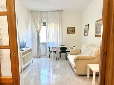 a living room with a couch and a table at 10 minuti da stazione Trastevere in Rome