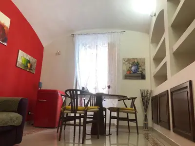 a table and chairs in a room with a window at Giancarla Luxury Apartment Rome San Lorenzo - Termini in Rome