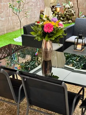 a vase filled with flowers sitting on a table at Romeantique in Zama in Rome