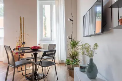 a dining room with a table and chairs at iFlat Modern & Relaxing apartment in Trastevere in Rome