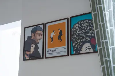a group of four posters hanging on a wall at San Paolo GreenHouse in Rome