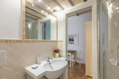 a bathroom with a white sink and a shower at iFlat Quiet & cozy apt a few steps from Vatican in Rome