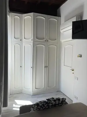 a room with white cabinets and a bed at Pietro's Central Apartament in Rome