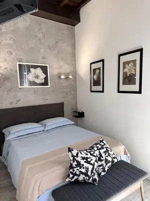 a bedroom with a bed and a bench in it at Pietro's Central Apartament in Rome