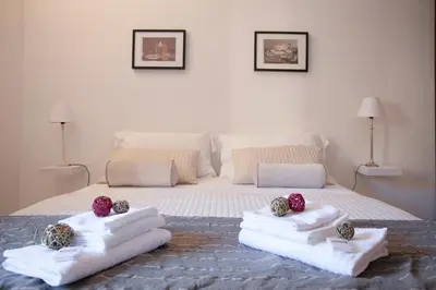 a bedroom with a bed with towels and balls on it at Magenta Luxury Purificazione in Rome