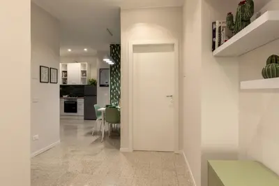 a hallway with a white door and a dining room at CASA VACANZA San LO' ZONA SAN LORENZO TERMINI ROMA in Rome