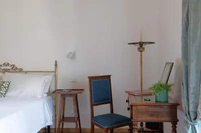 a bedroom with a bed and a chair and a desk at iFlat Pantheon Peaceful & Comfortable Apartment in Rome