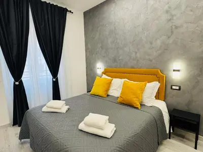a bedroom with a large bed with yellow pillows at Turati Inn in Rome