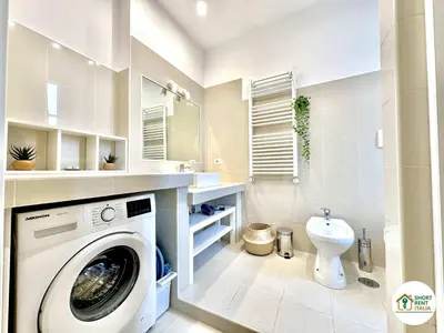 a bathroom with a washing machine and a sink at Corso Francia - Exclusive House in Rome