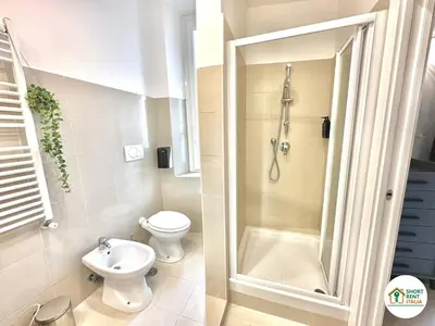 a bathroom with a shower and a toilet and a sink at Corso Francia - Exclusive House in Rome