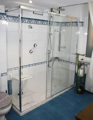 a glass shower in a bathroom with a toilet at Colosseo Vintage Apartment in Rome