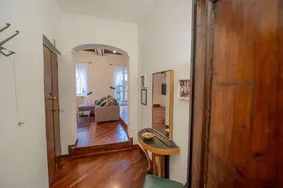 a living room with a wooden door and a living room at Pantheon Terrace 2 BR Apartment in Rome