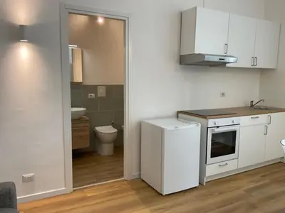 a kitchen with white cabinets and a sink and a toilet at Vatican New home in Rome in Rome