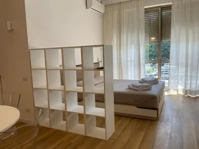 a bedroom with a bed and a large book shelf at Vatican New home in Rome in Rome